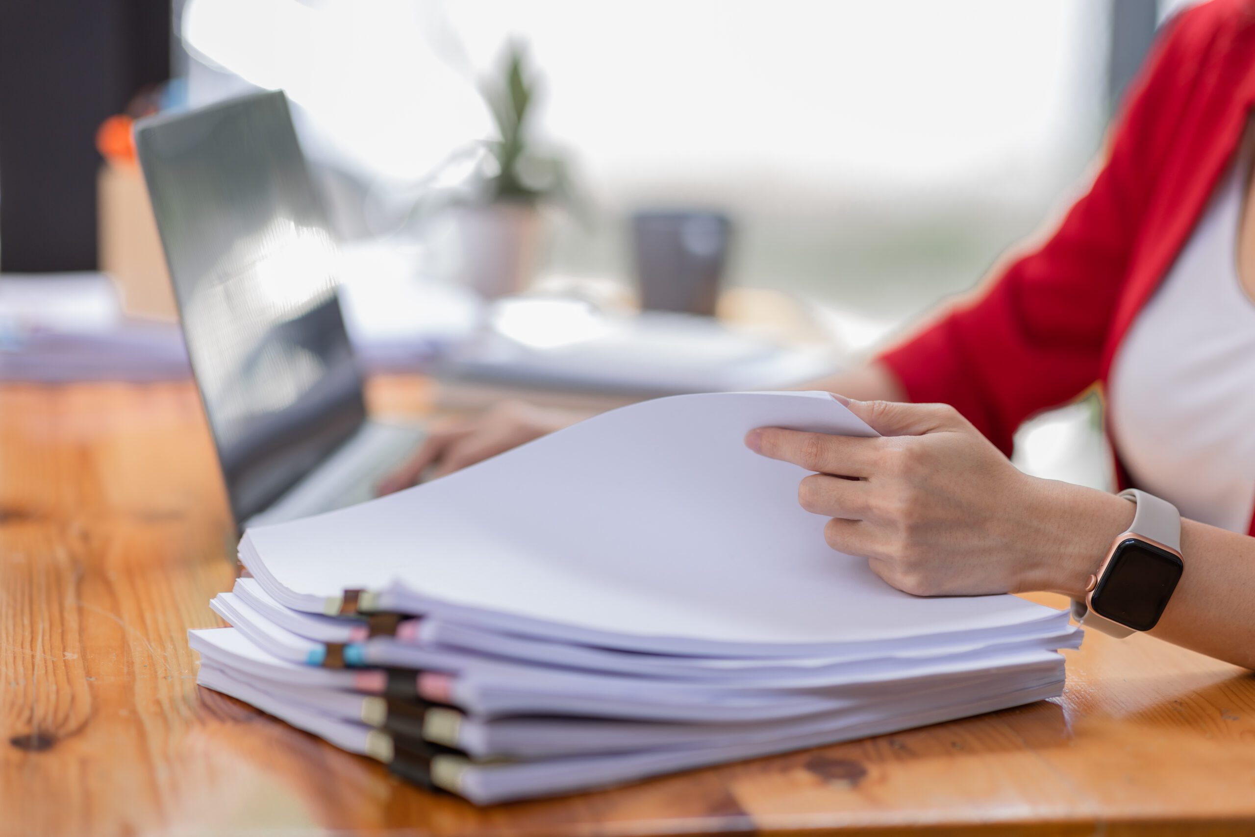 Woman sorting through a stack of paper